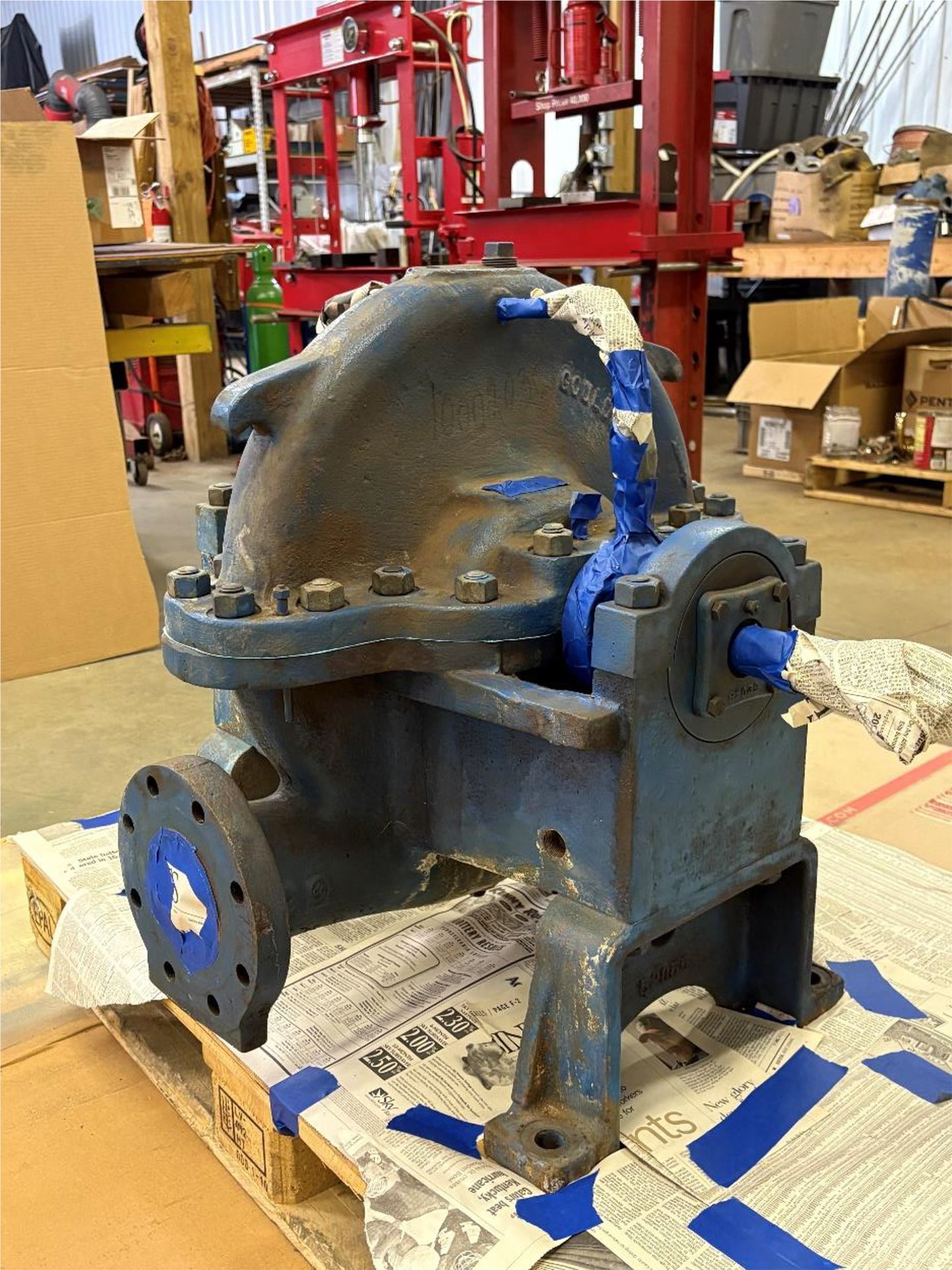 A machine is sitting on top of a newspaper on a pallet