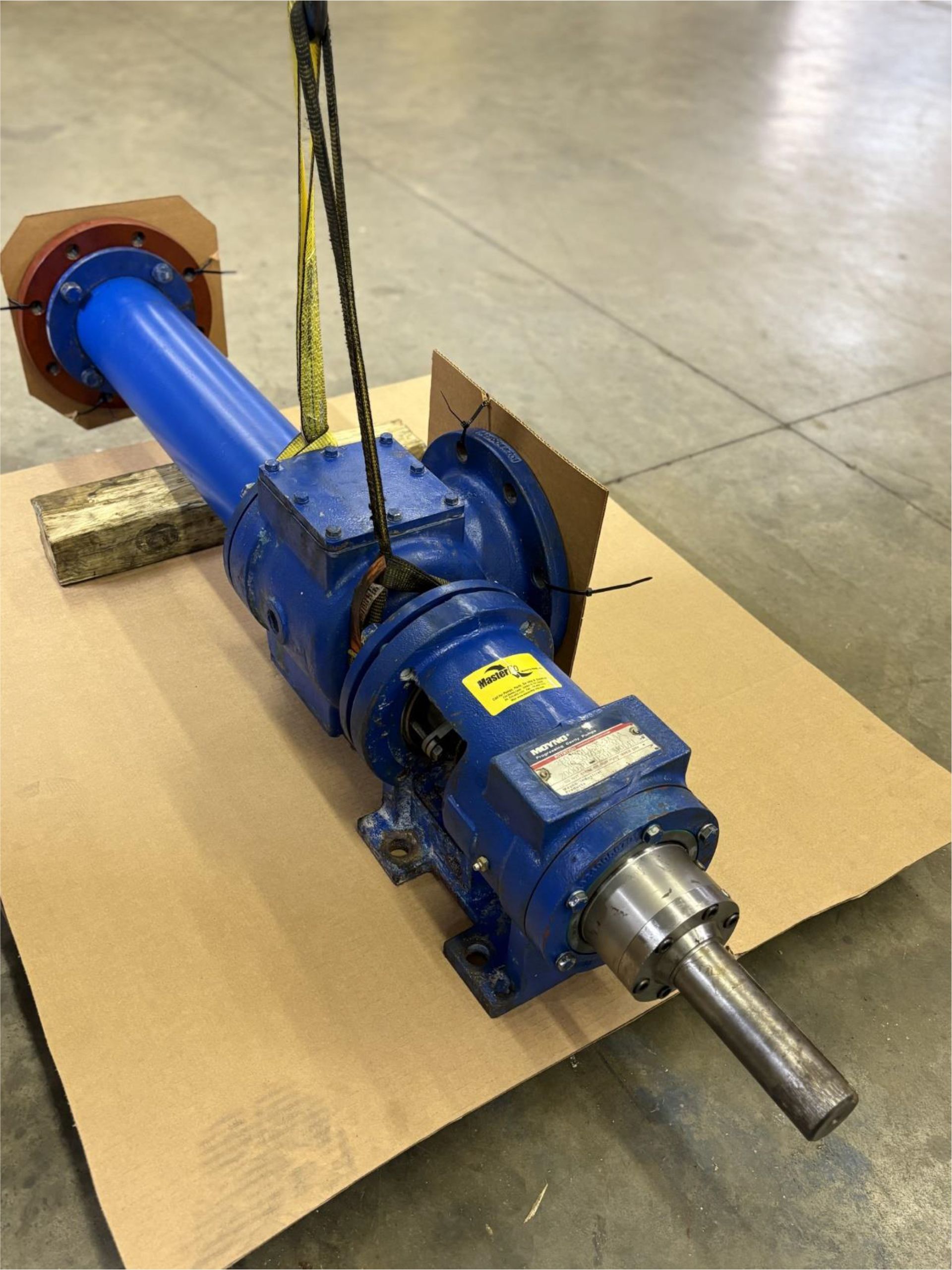 A blue pipe is sitting on top of a cardboard box