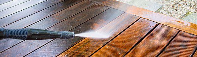 High water pressure cleaner on wooden surface