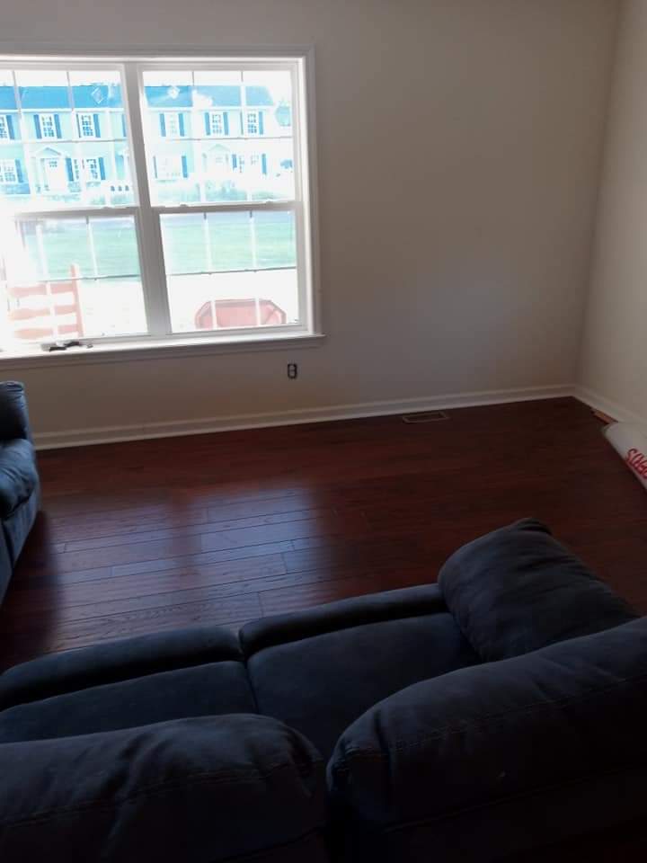 A room with two sofas overlooking the outdoors through its window