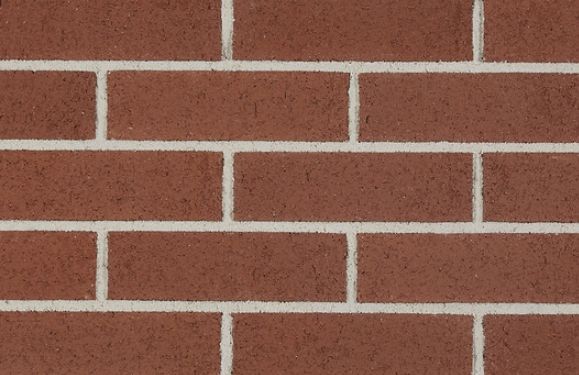 Close-up of a red brick wall with light gray mortar lines