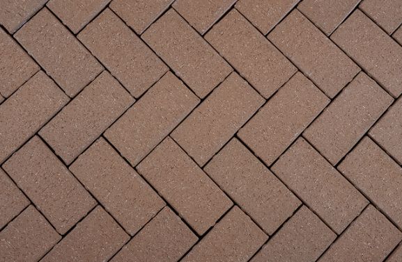 Brown herringbone brick pavement pattern