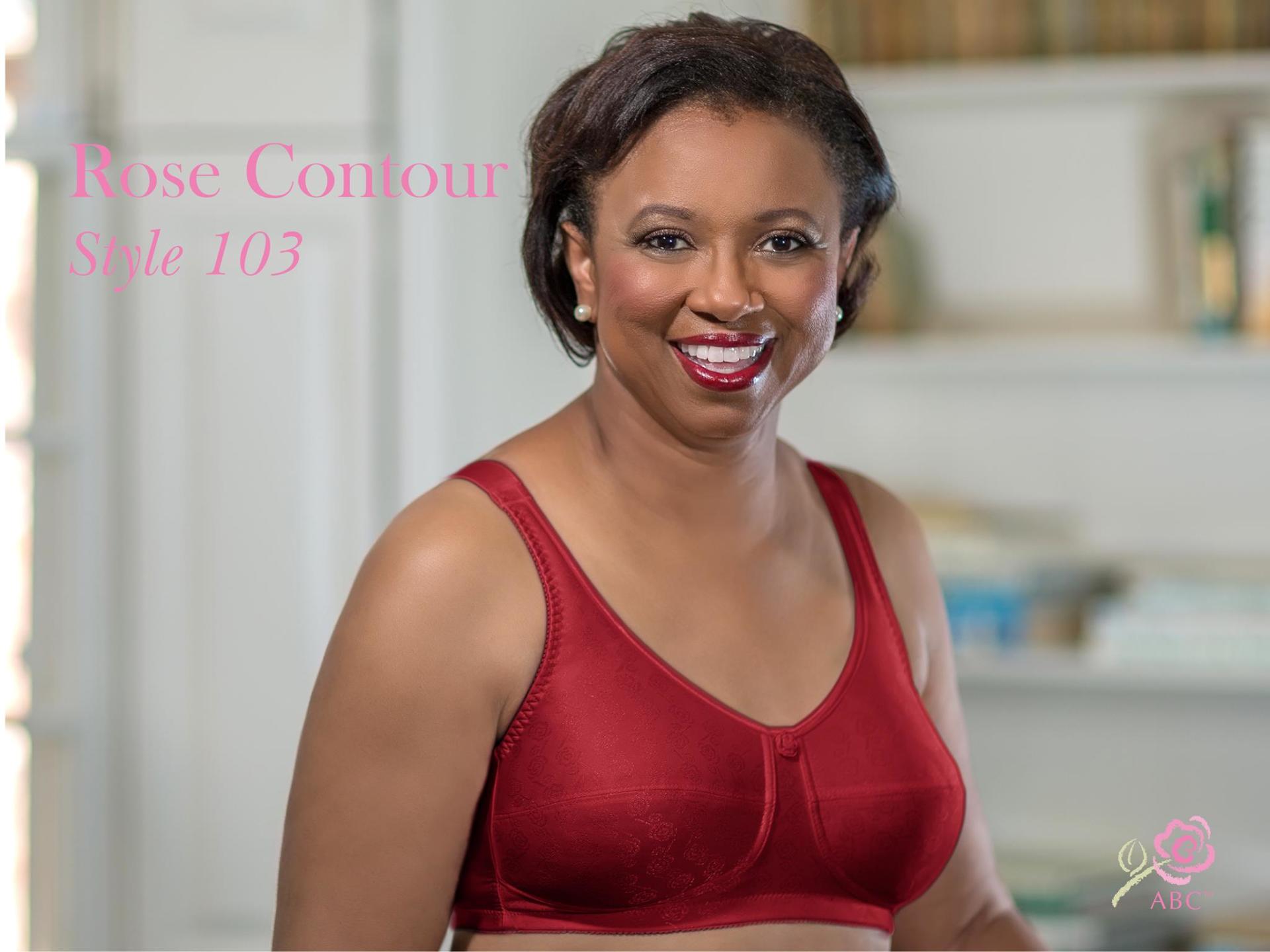 A woman is wearing a red bra and smiling.