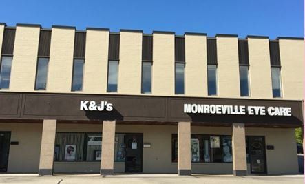 A building with a sign that says k & j 's monroeville eye care