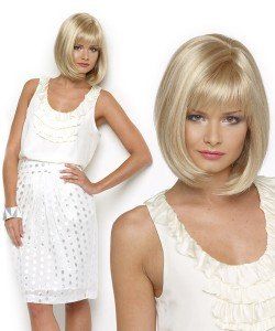 A woman is wearing a blonde wig and a white dress.