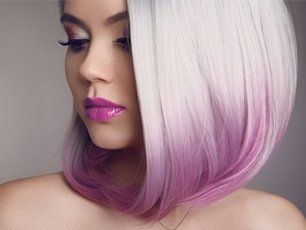 A woman with white hair and purple highlights is wearing purple lipstick.