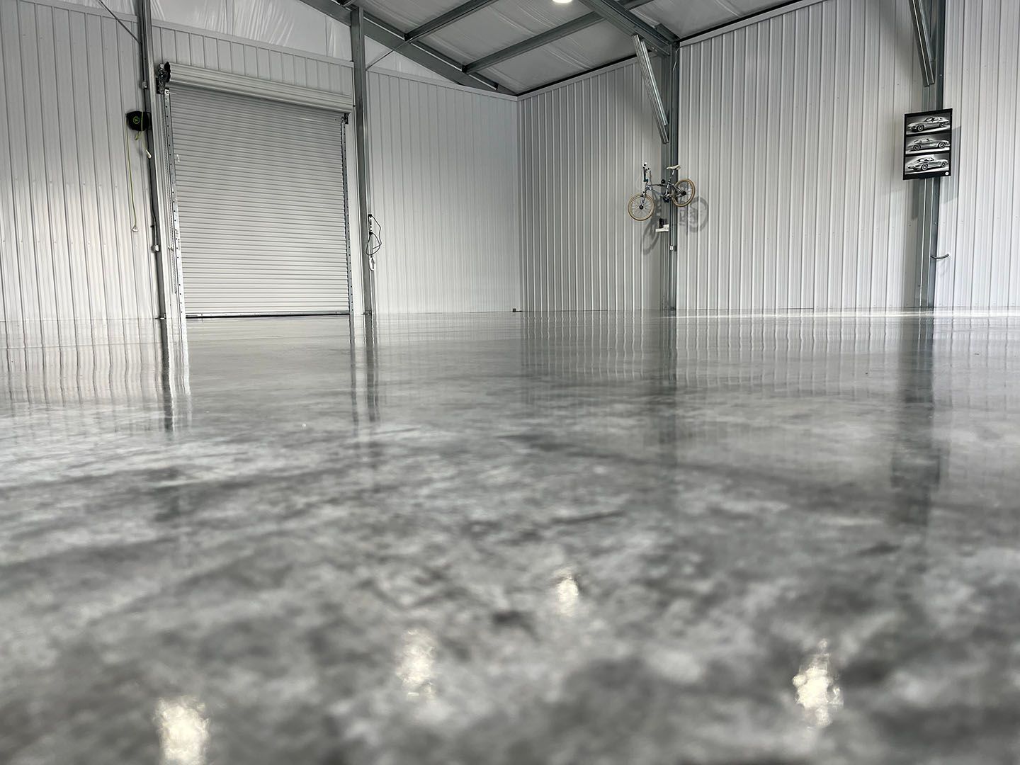 Empty metal room with corrugated walls and a glossy reflective floor