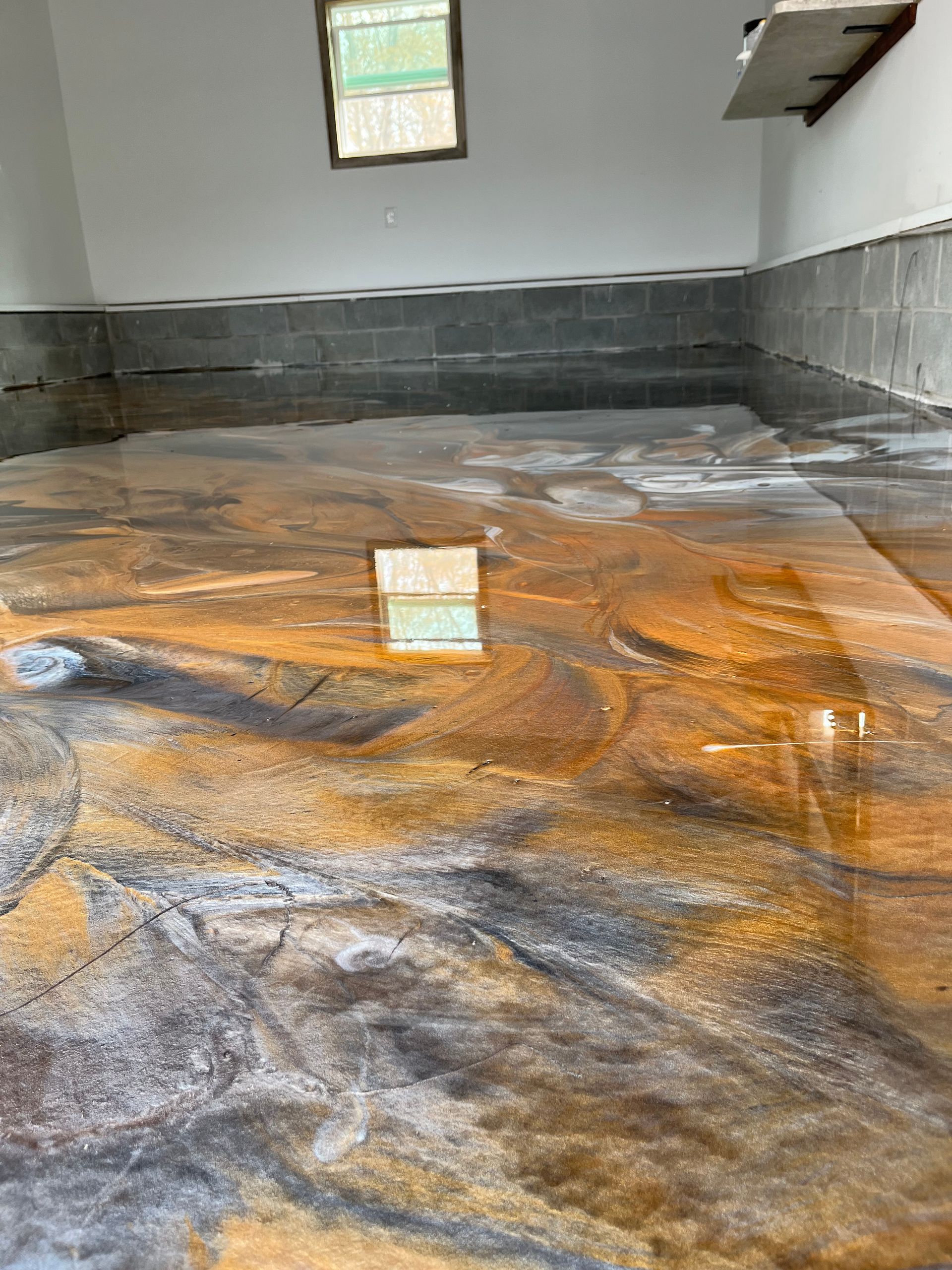 Empty indoor room with a fresh orange and gray epoxy floor finish