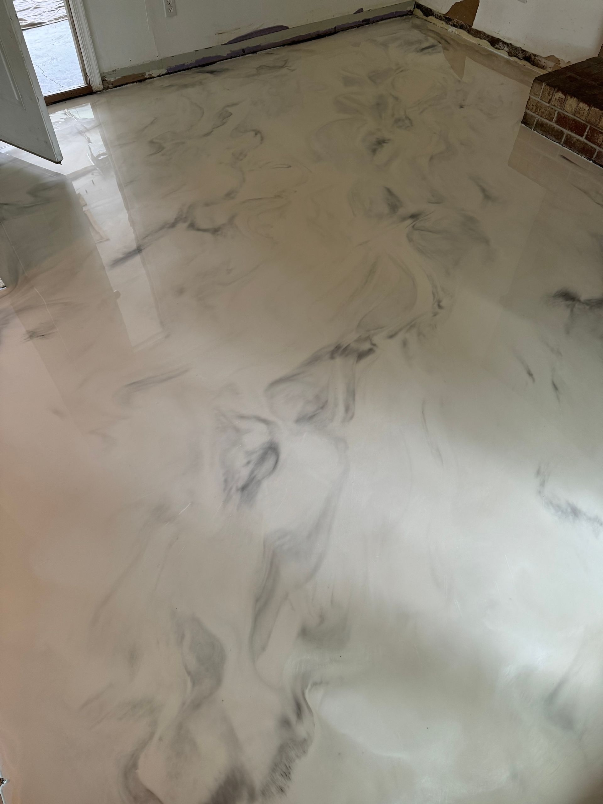 Polished marble floor with gray veining in a hallway or room