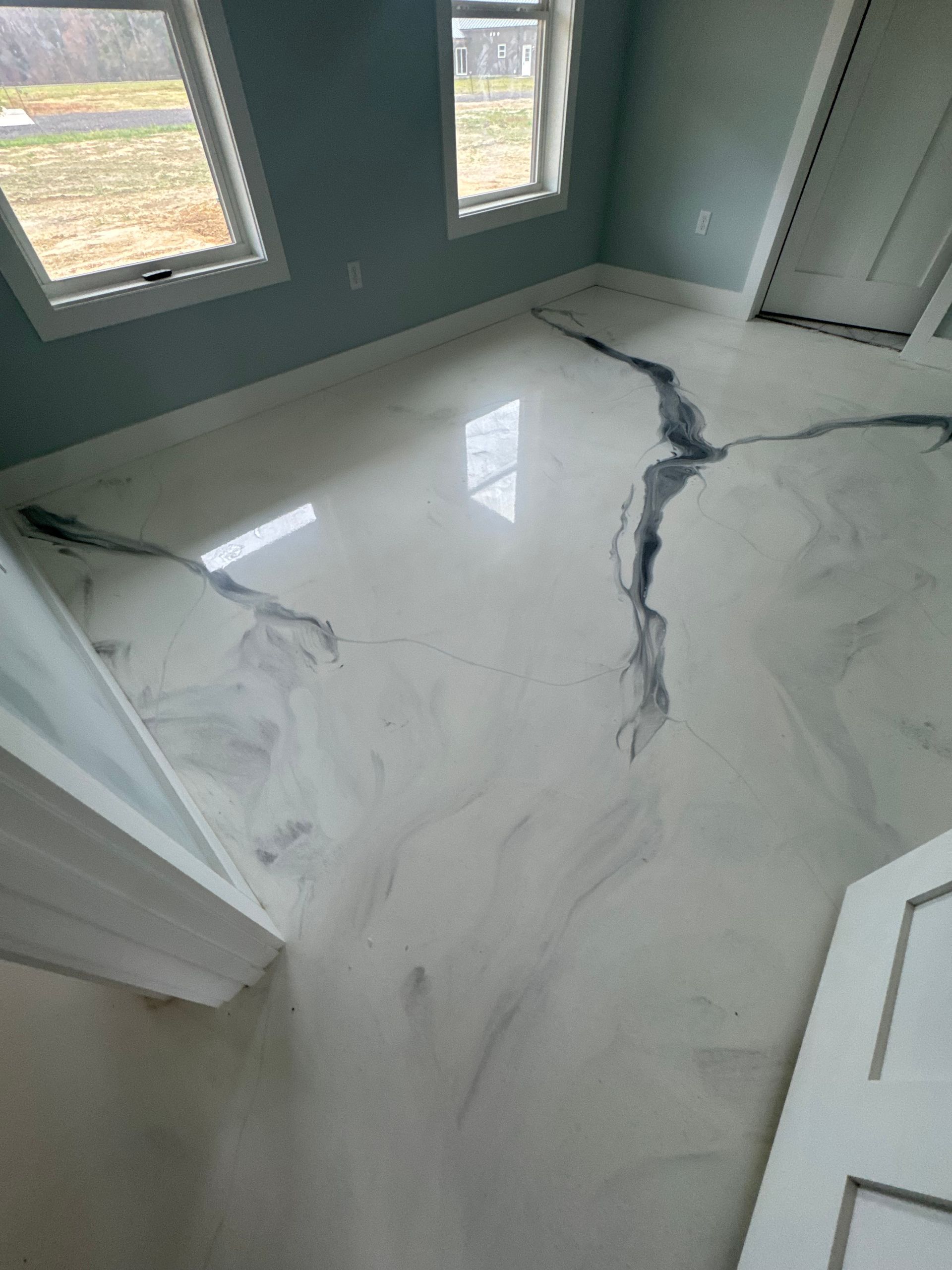 Flooded room with cracked white marble floor and reflections from windows