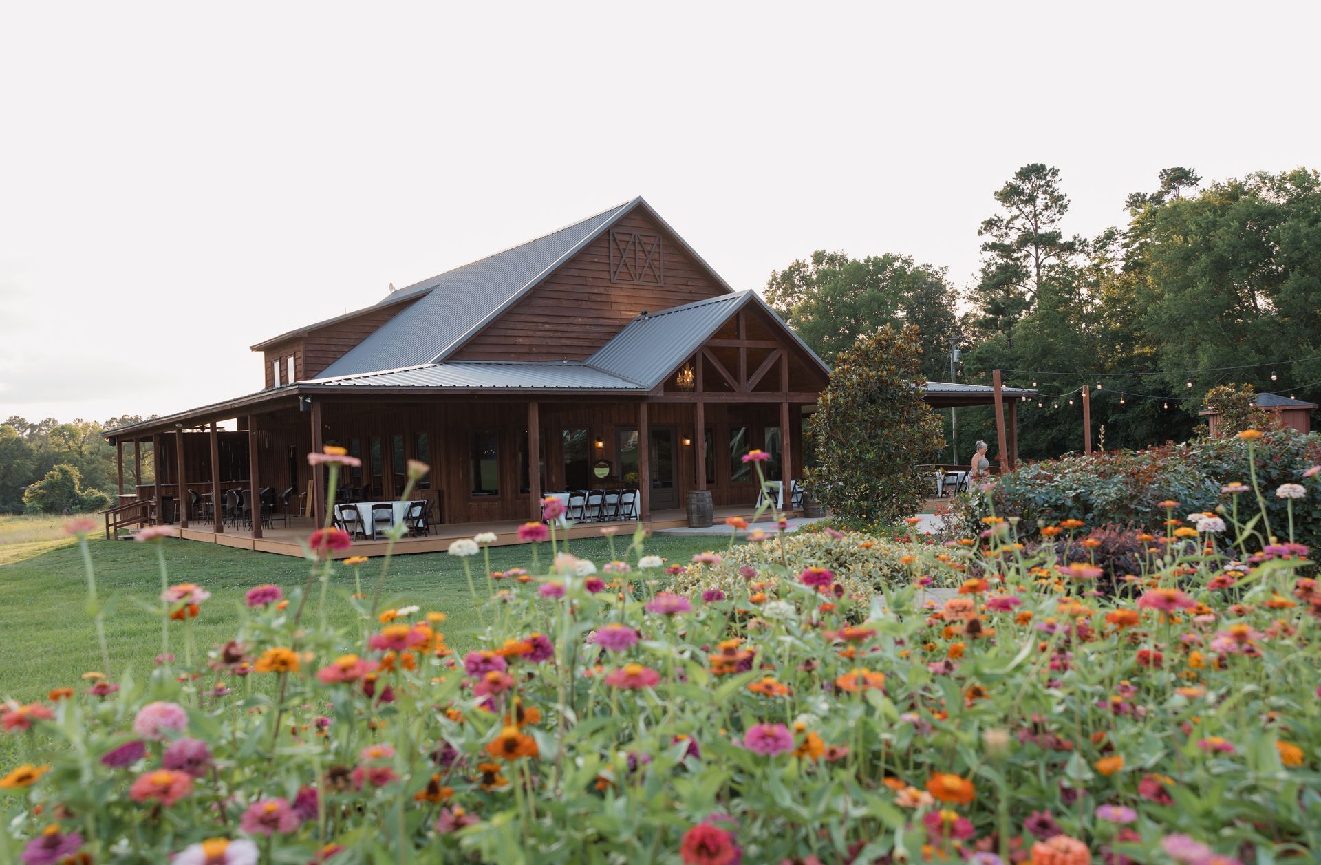 Wooden cabin beside a wildflower meadow at sunset