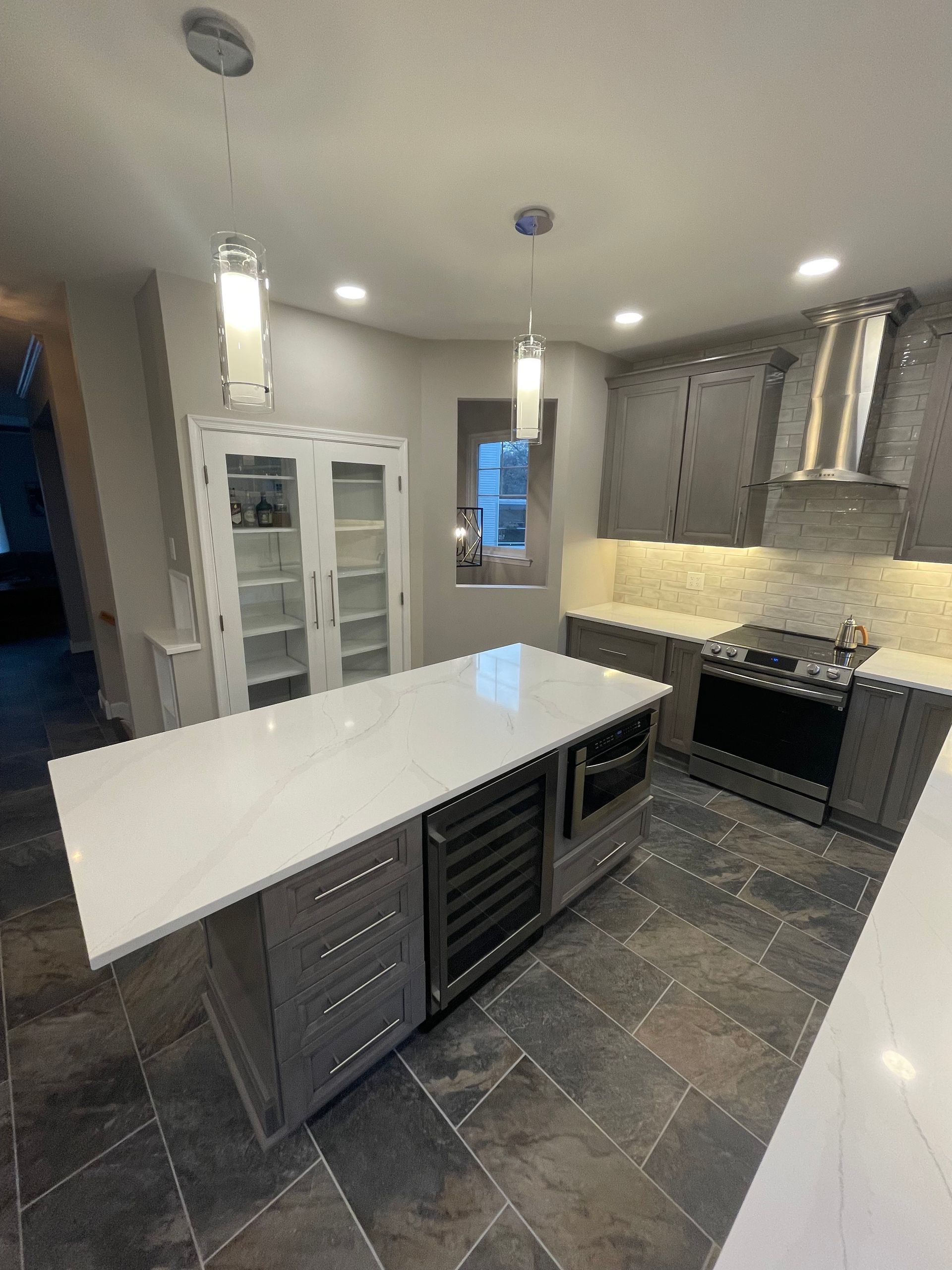 A kitchen with a large island in the middle of it.