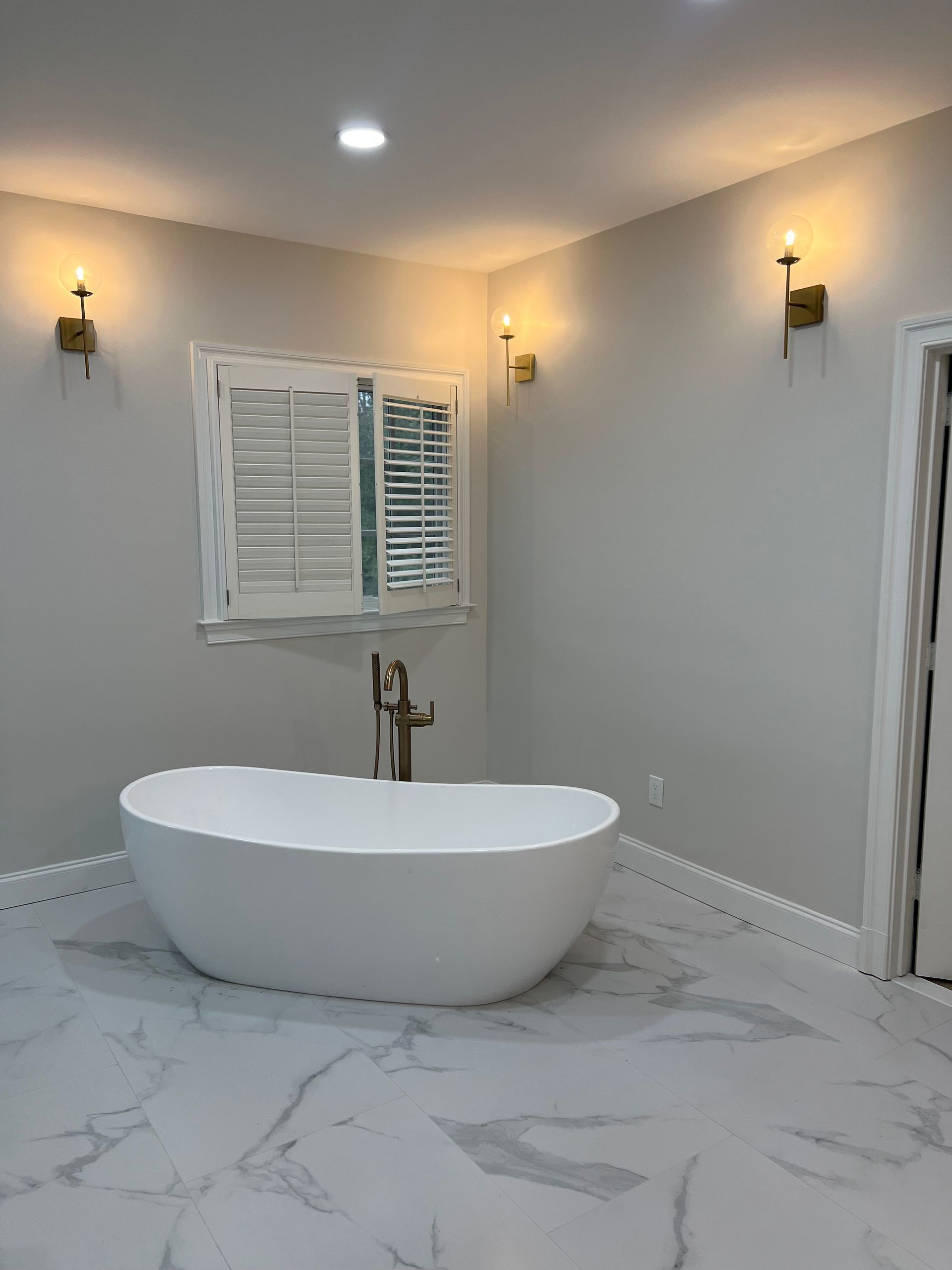 There is a bathtub in the middle of the bathroom.