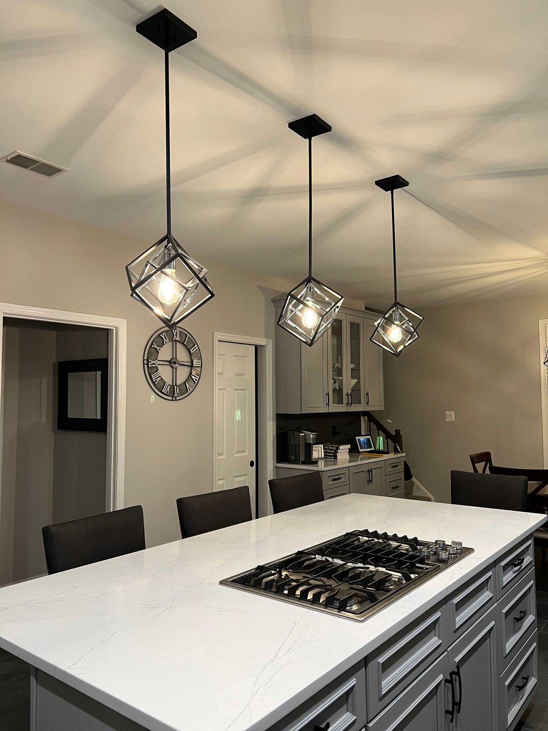 A kitchen with a large island and a stove top oven.