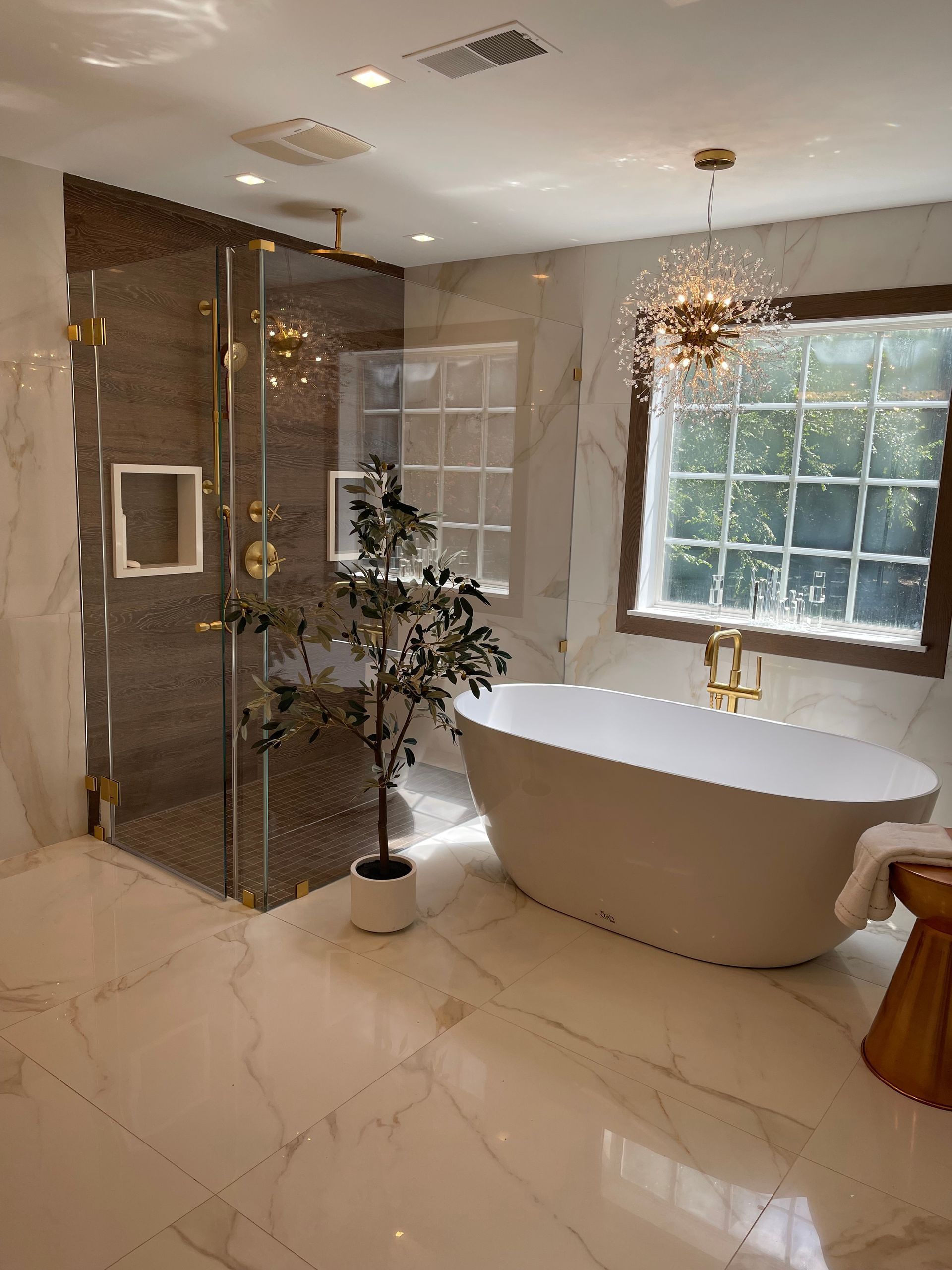 A bathroom with a tub, shower, and window.