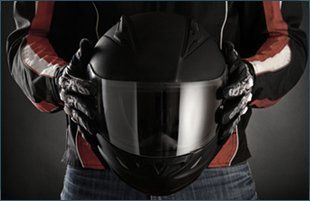 Motorcyclist with helmet in his hands