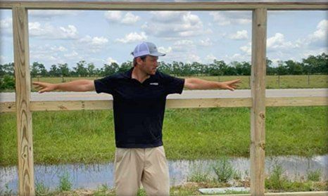 Man measuring the fence