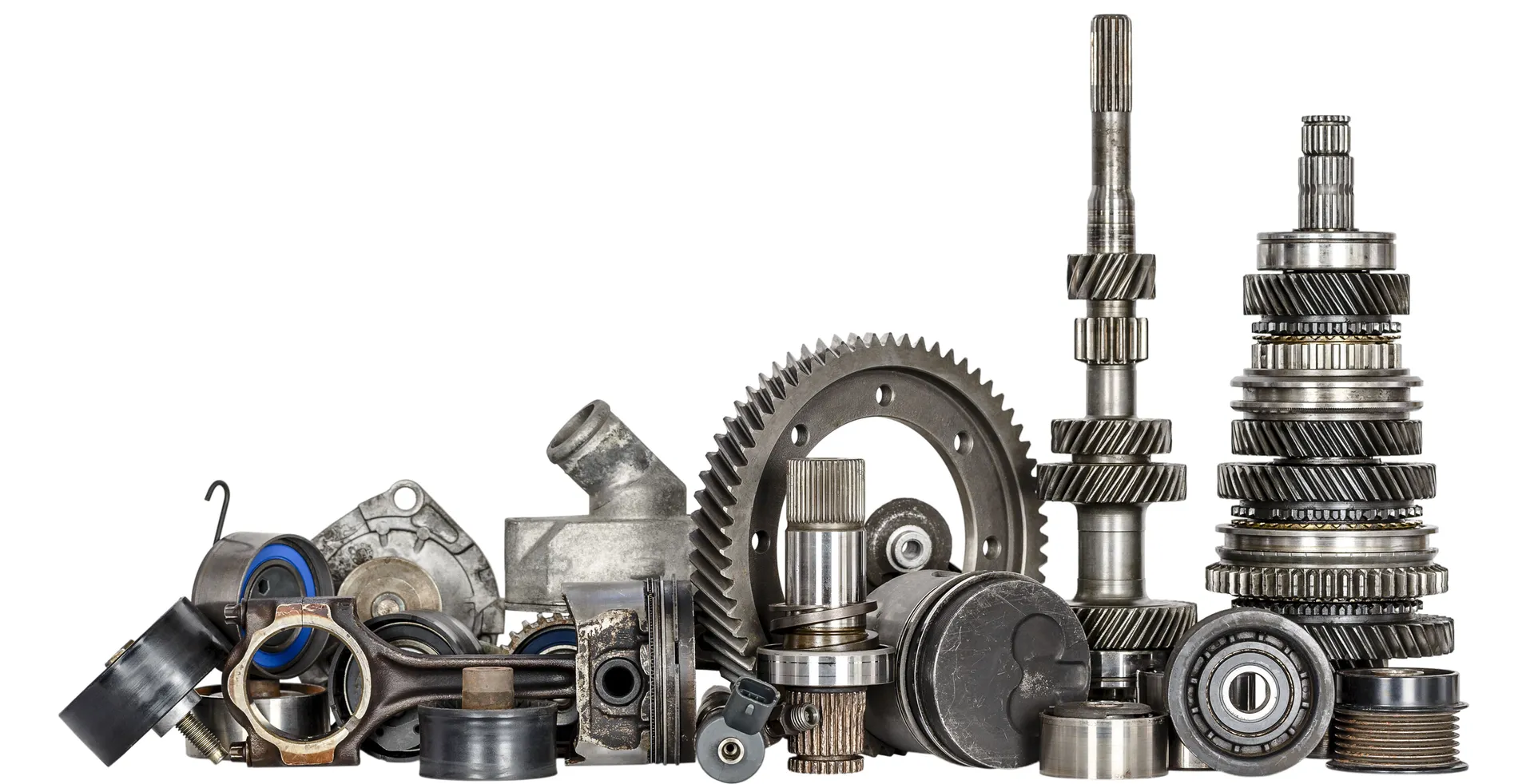 Collection of various used metal car parts on a white background.