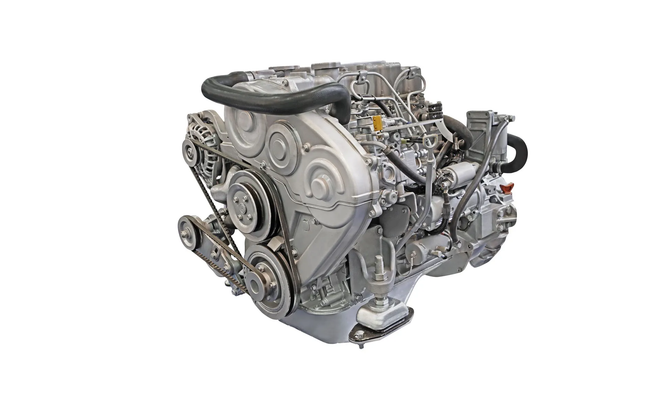 Silver diesel engine, showing belts, pulleys, and various components.