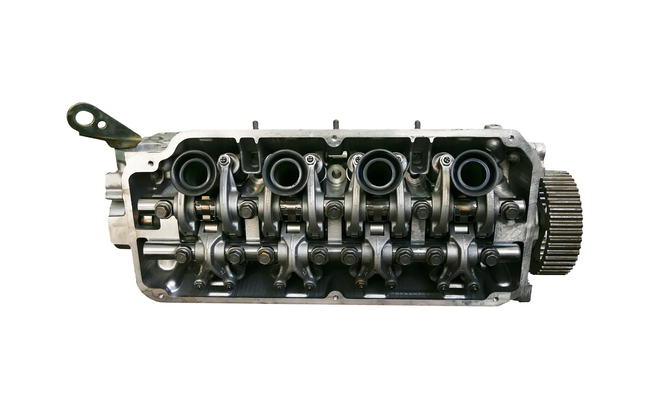 Engine cylinder head with exposed valves and camshaft.