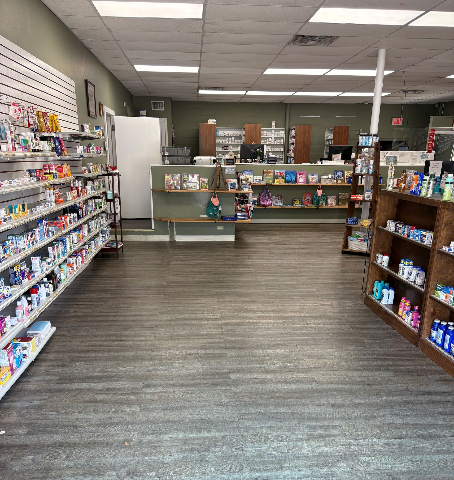 Retail store aisle with shelves of colorful products and a service counter at the back.