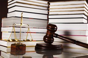 Law books, scale and gavel