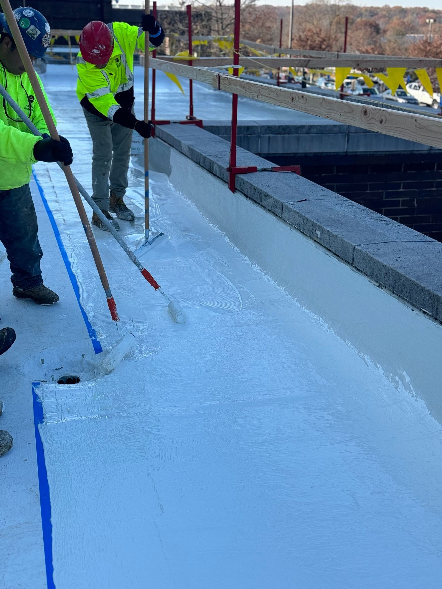 A group of construction workers are working on a roof.