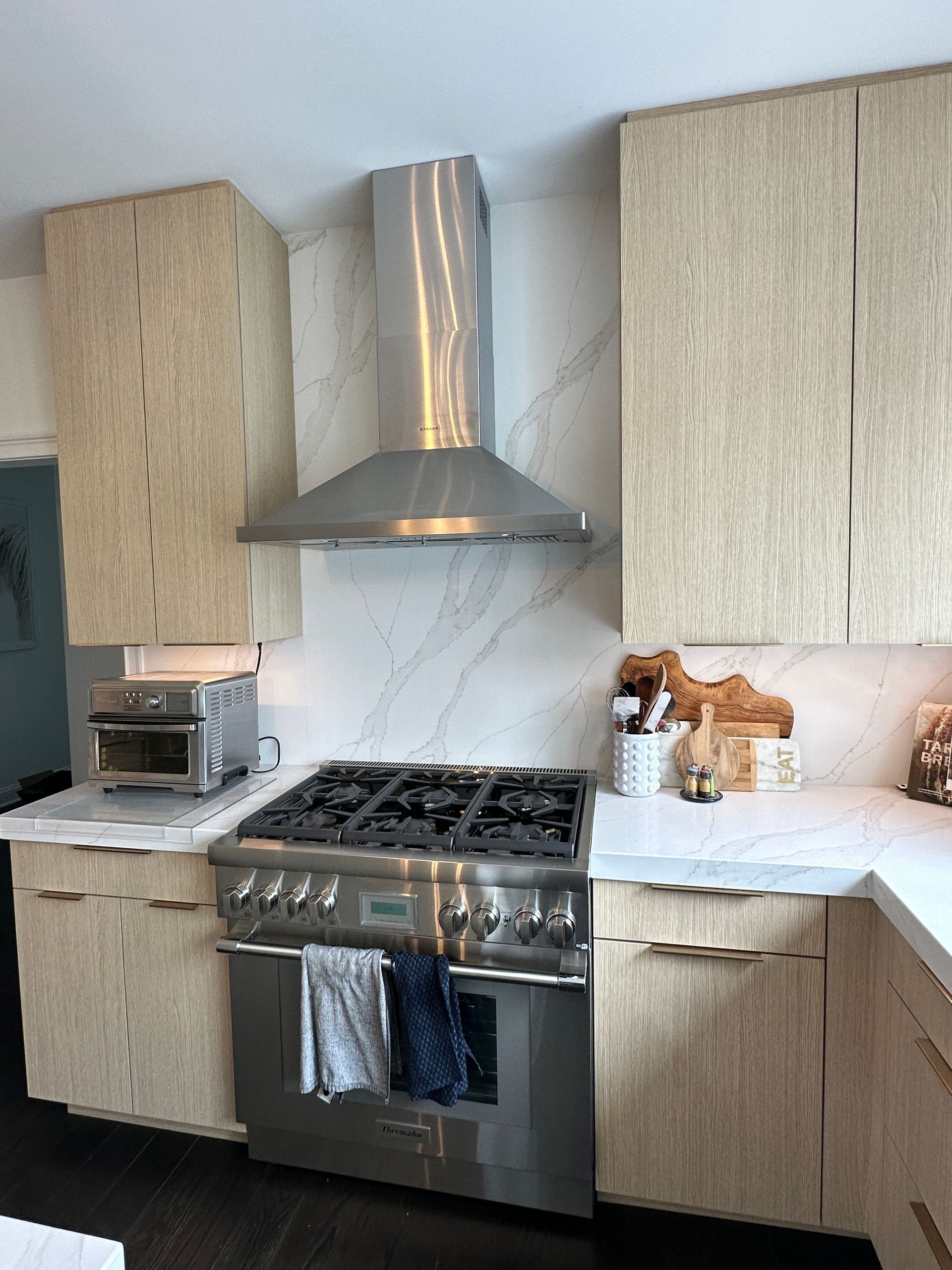 A kitchen with stainless steel appliances and wooden cabinets