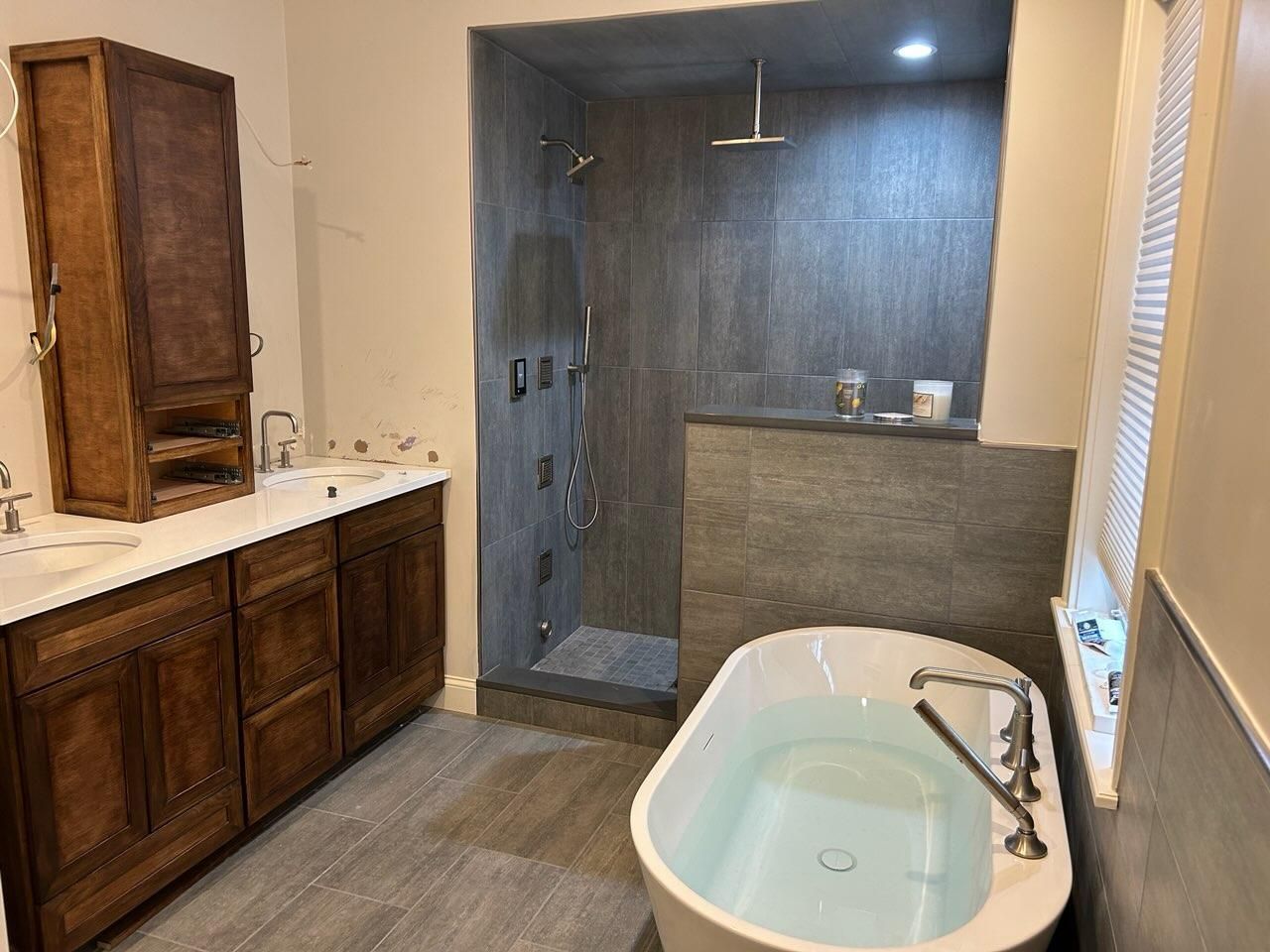 A bathroom with a bathtub and a walk in shower.