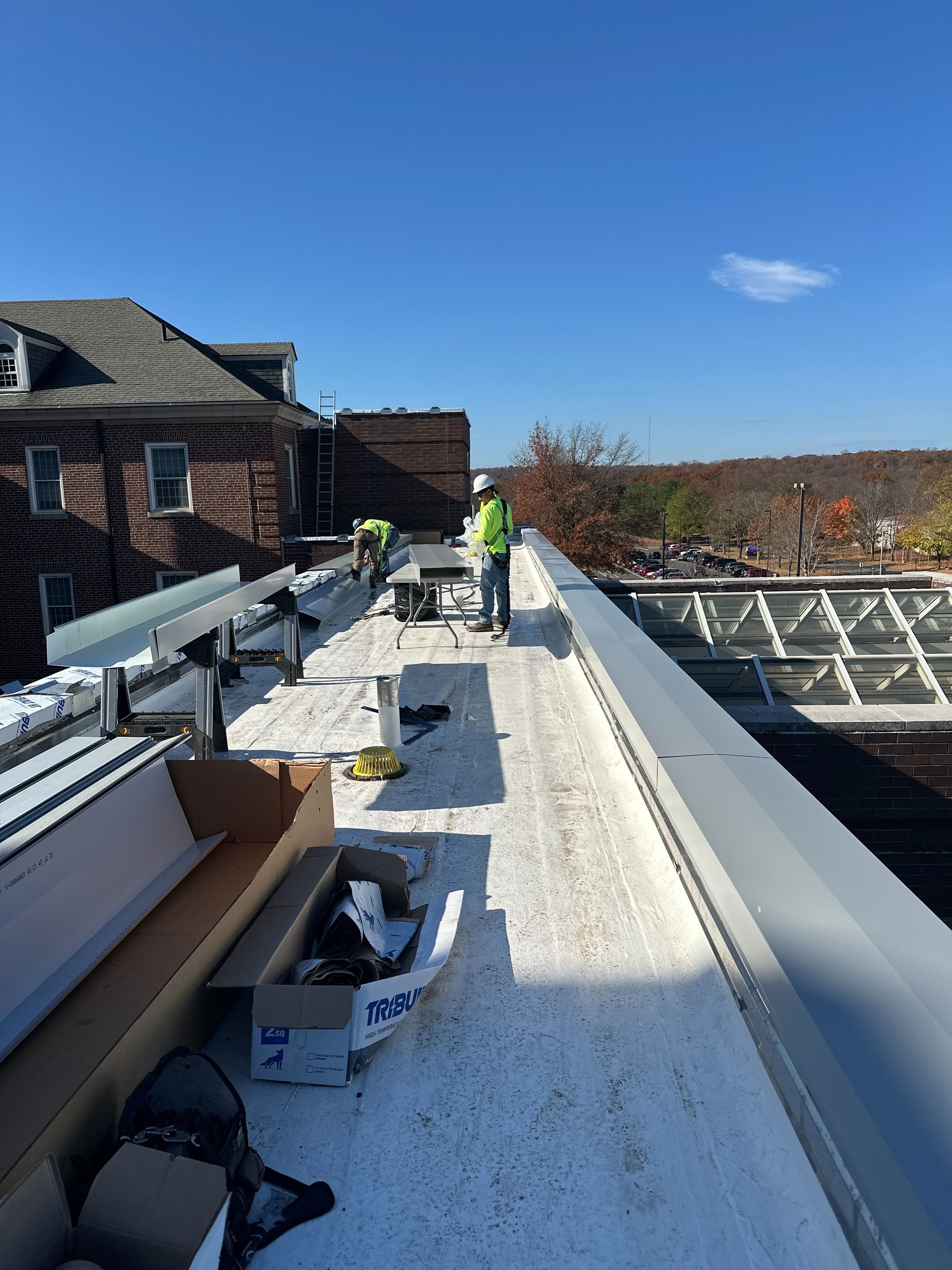 A man is standing on the roof of a building.