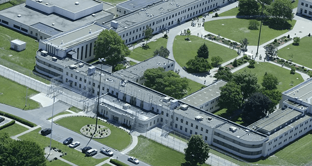 An aerial view of a large prison with lots of buildings and trees.