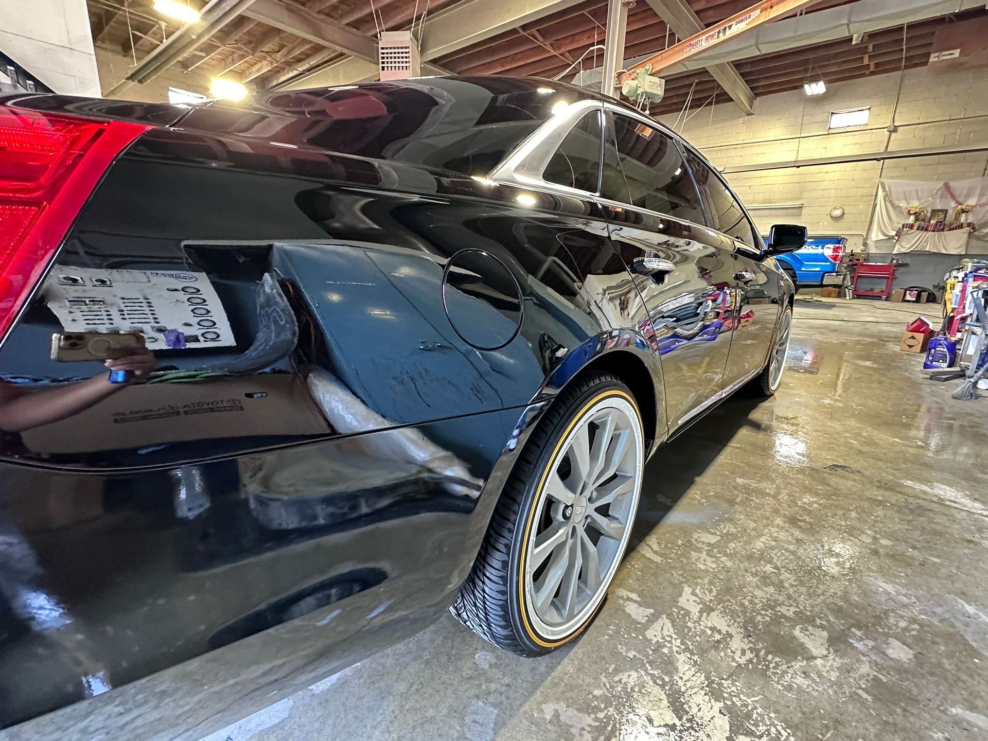 A black car is parked in a garage.