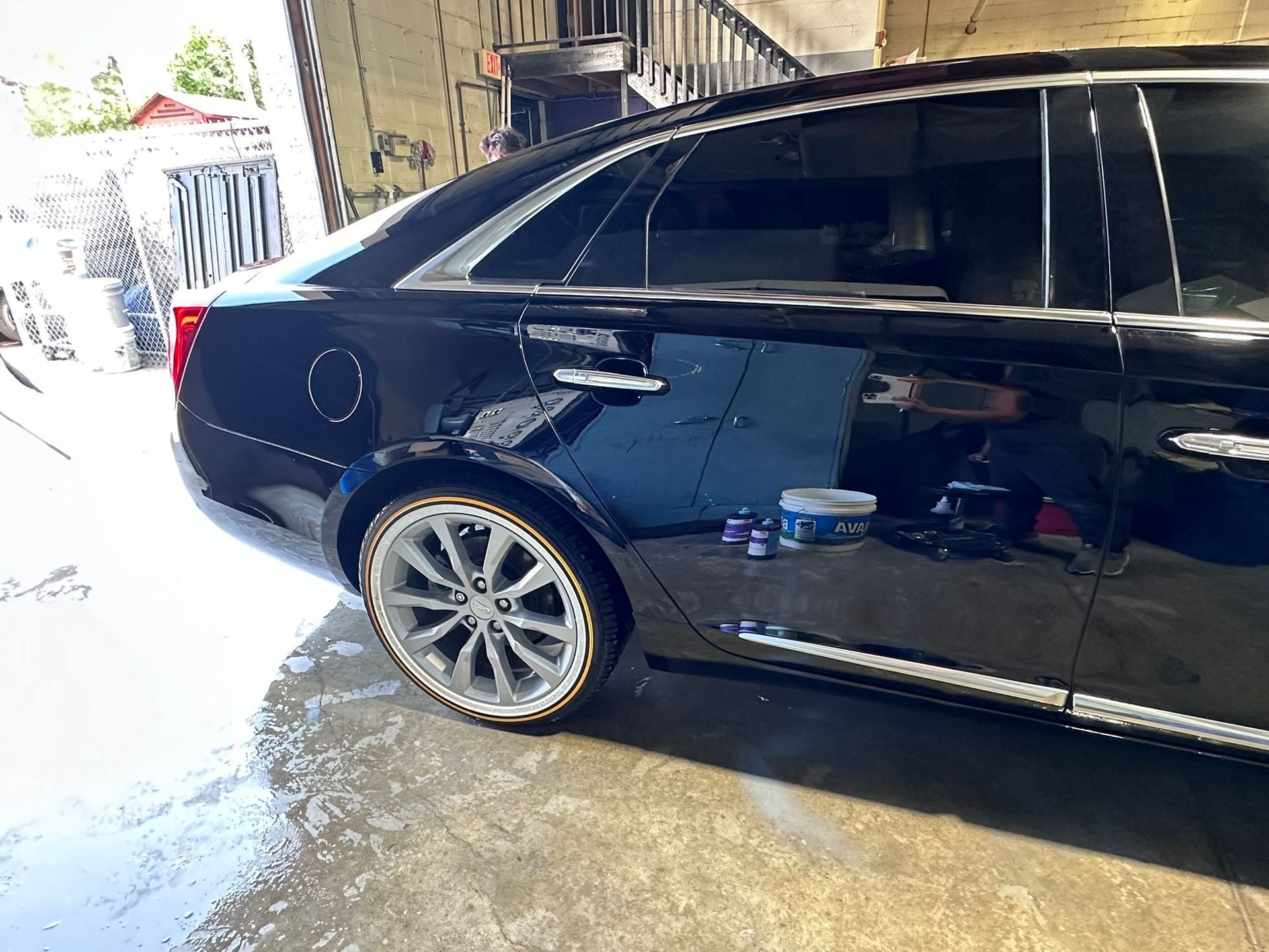 A black car is parked in a garage.
