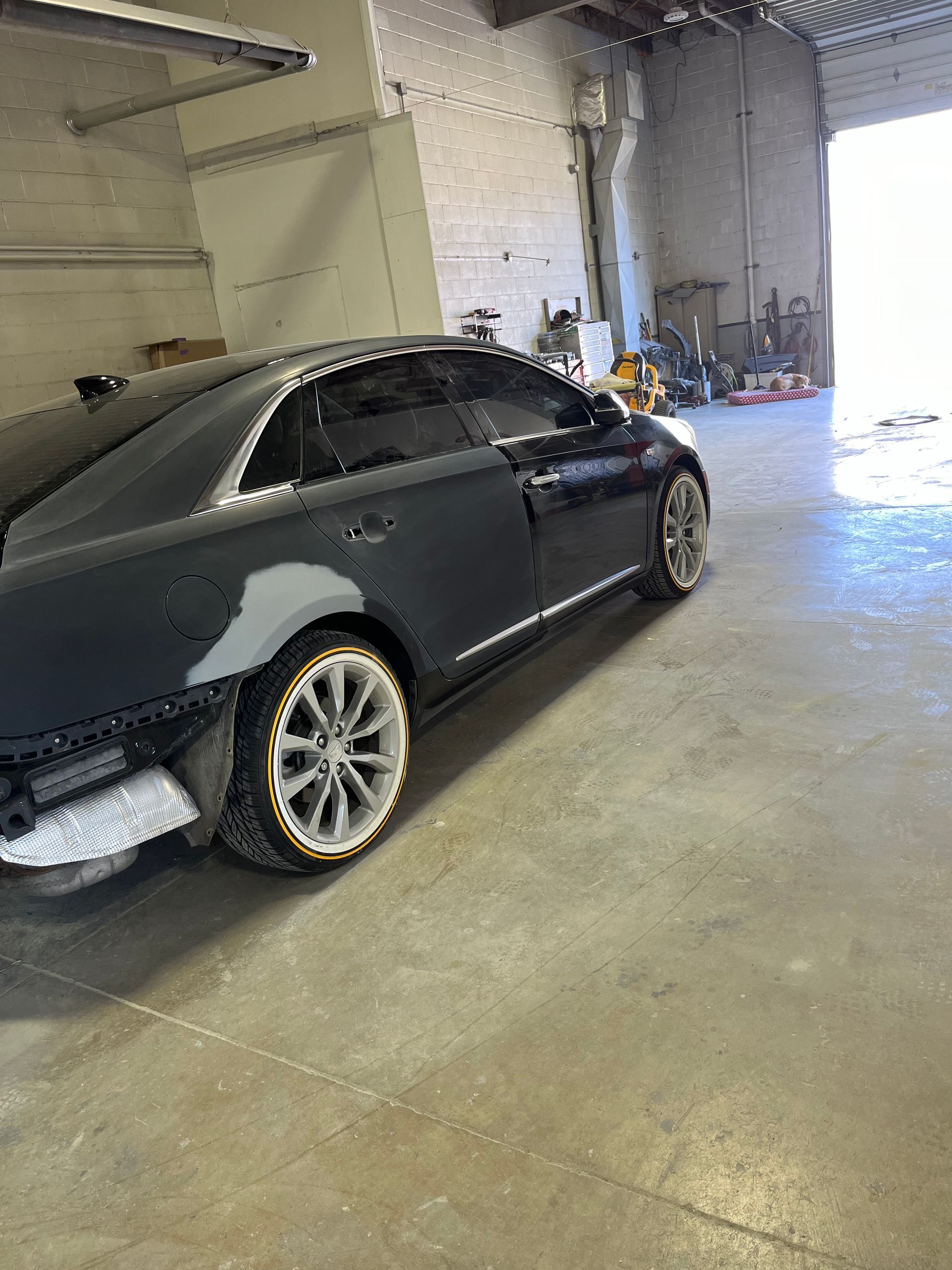 A black car is parked in a garage.