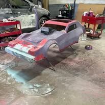 A rc car is being built in a garage.