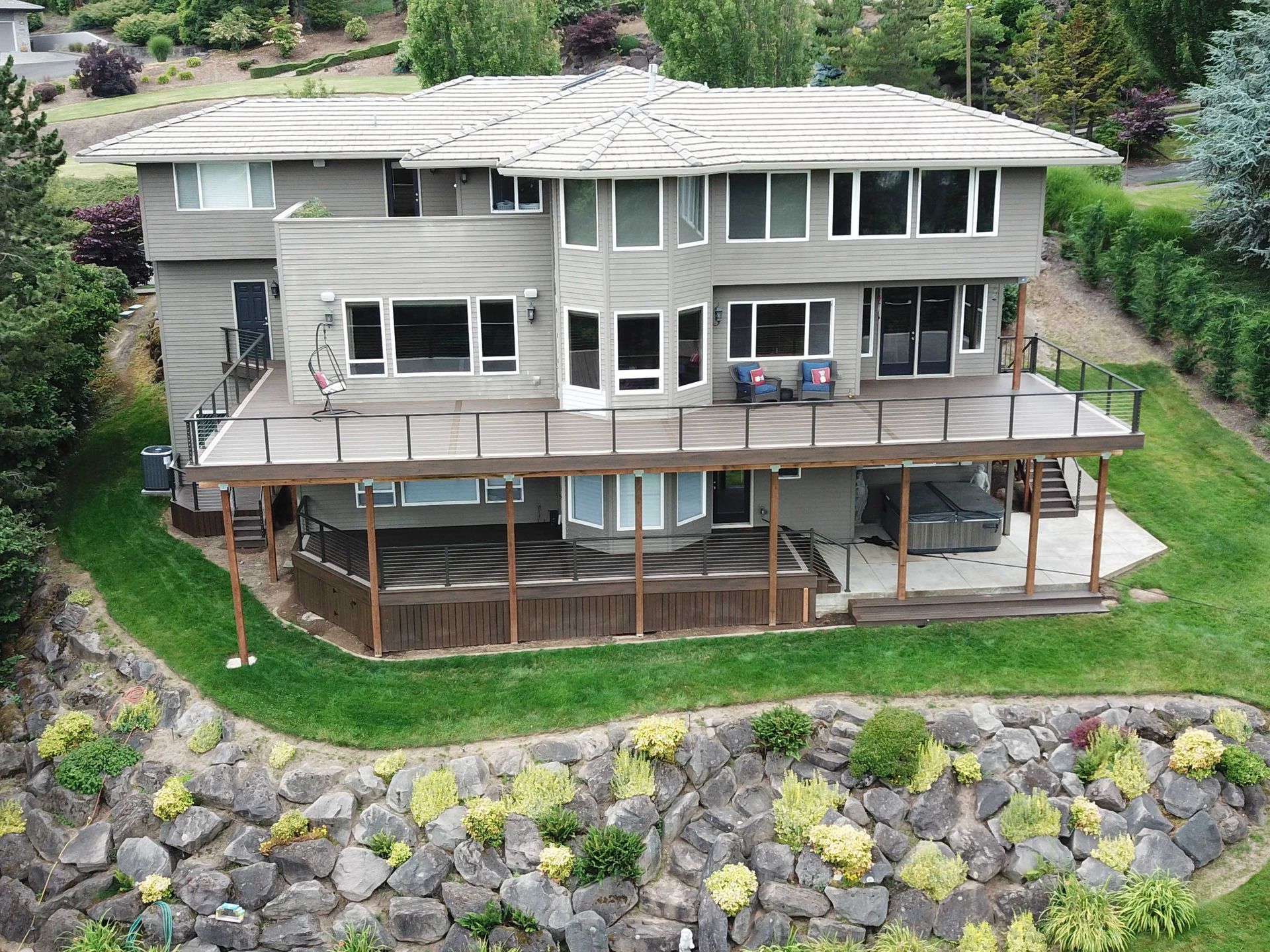 An aerial view of a large house with a large deck
