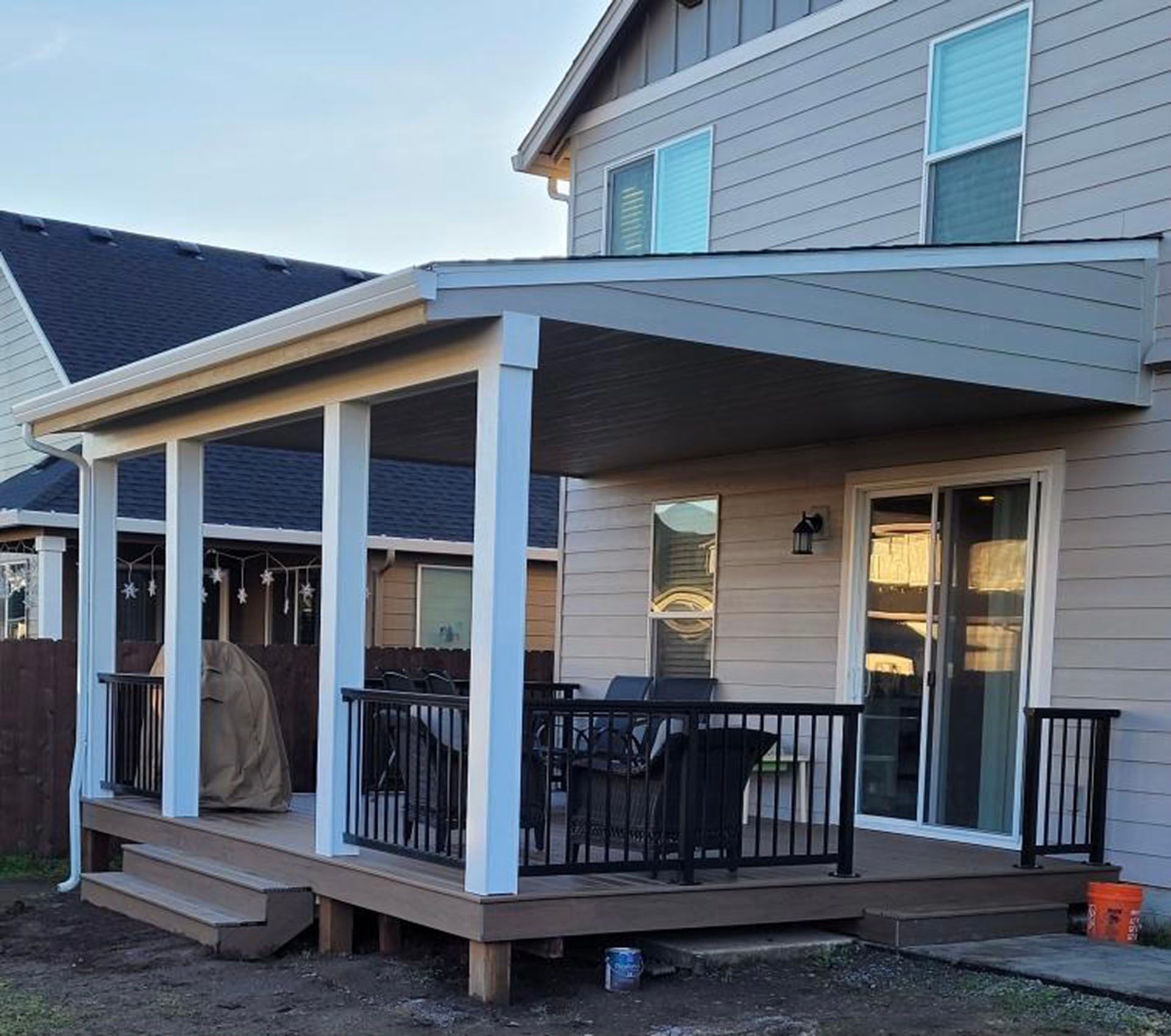 A house with a porch and a grill on it.