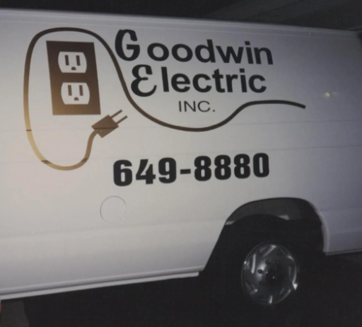 White Goodwin Electric service van with logo and phone number 649-8880 at night