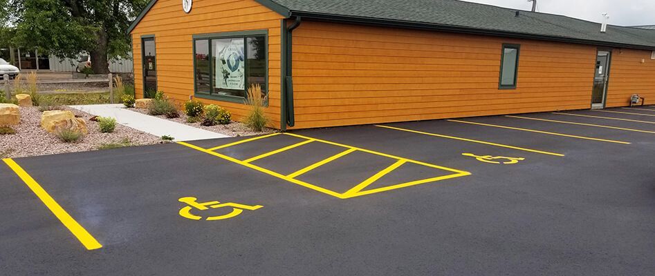 There is a handicapped parking spot in front of a building.