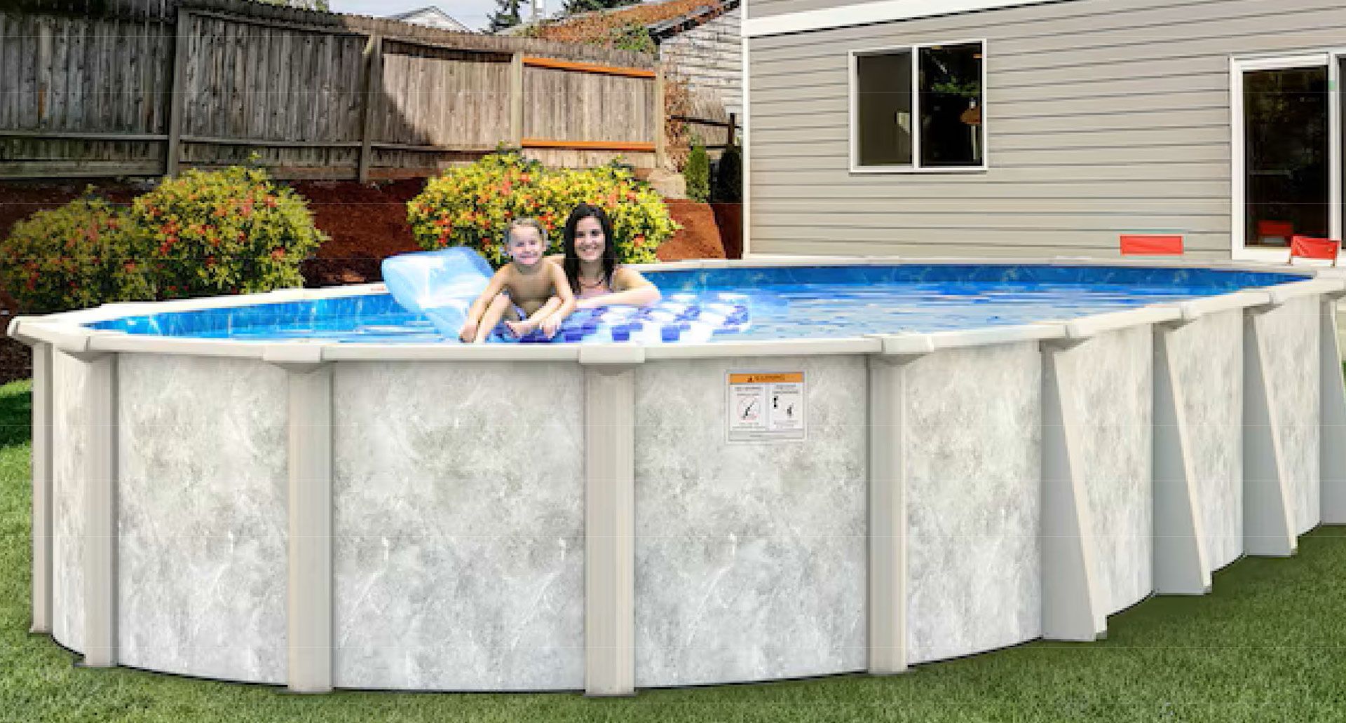 Above-ground pool in a backyard with two people relaxing in the water