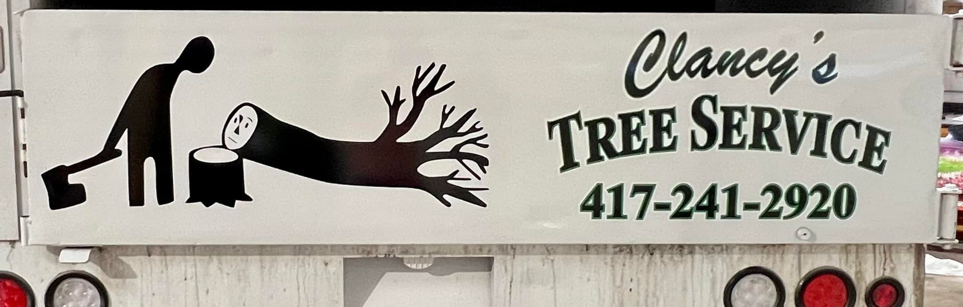 Clancy’s Tree Service truck sign with black tree-cutting logo and phone number 417-241-2920