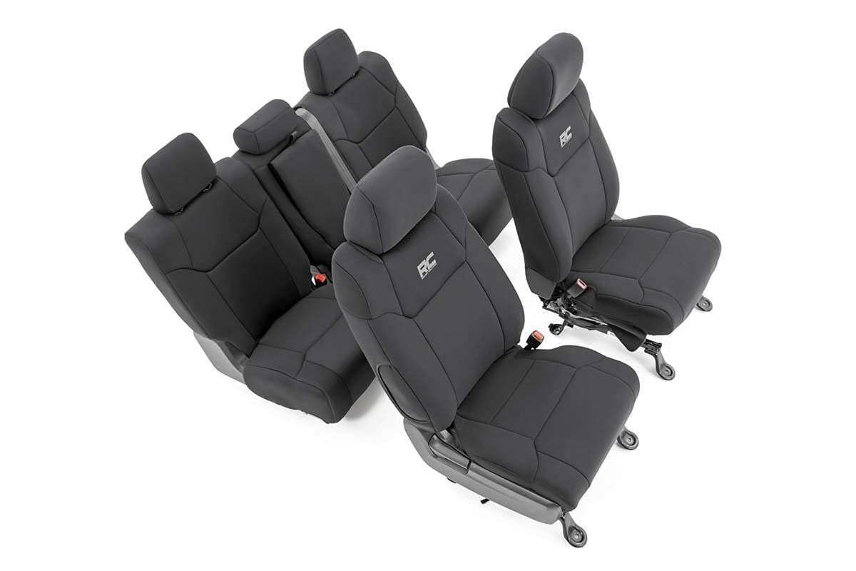 Four black and gray car seats arranged in a product display on a white background