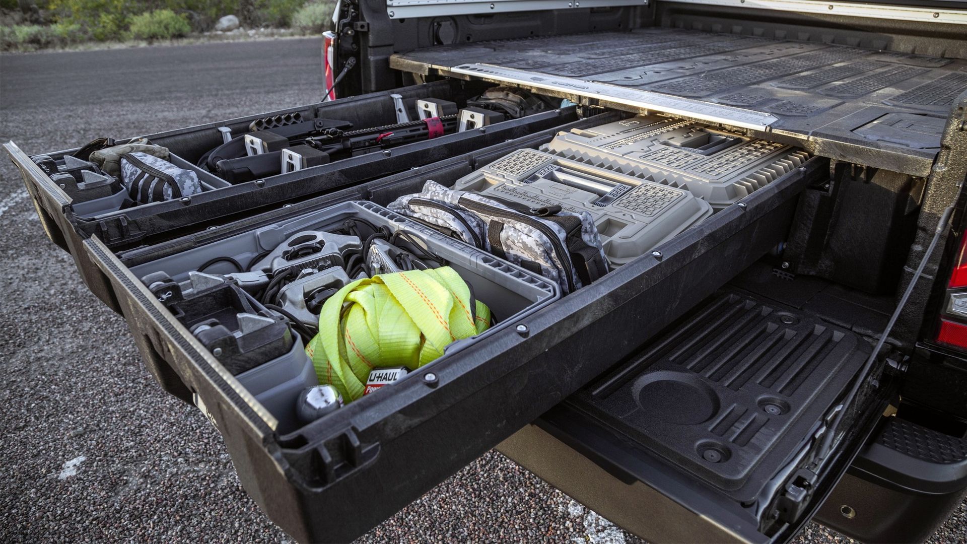 Fold-out bike rack loaded with bicycles, including a neon yellow bag, extended from a vehicle bed.