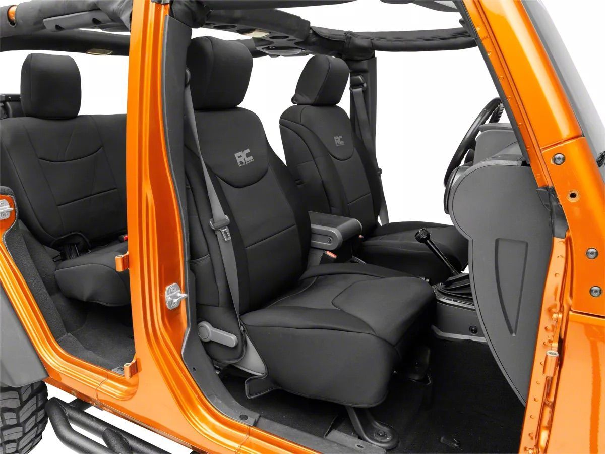 Black seats in an orange off-road vehicle with open doors and a roof frame
