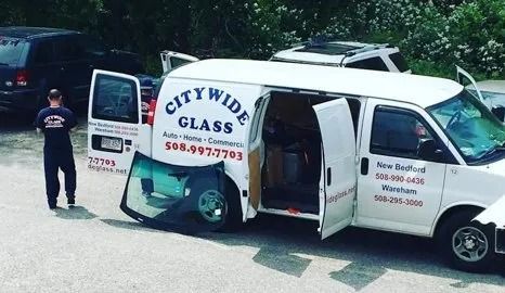 White Citywide Glass service van with open side door parked on a street, logo and phone number visible