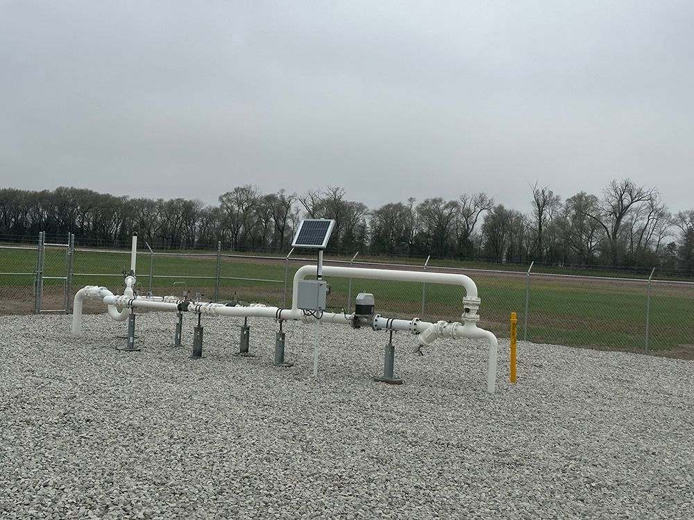 A row of pipes with a solar panel on top