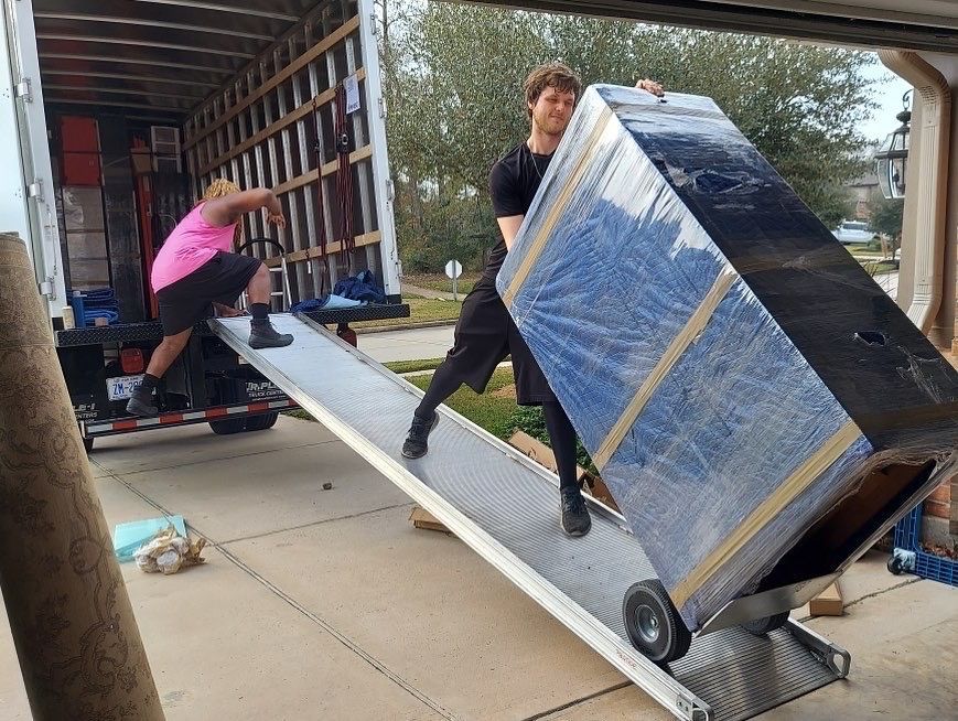 A moving truck is parked in front of a house.