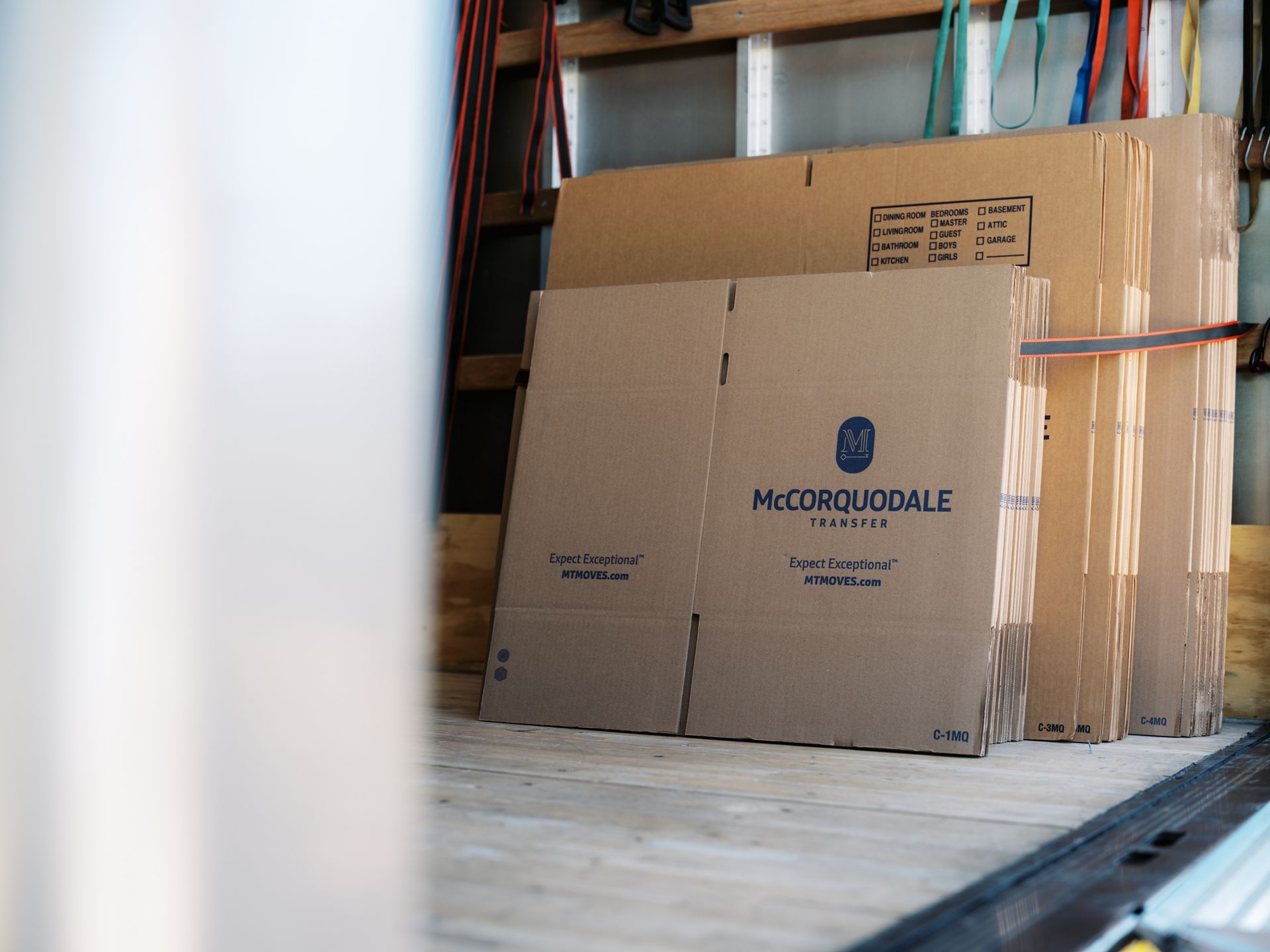Cardboard boxes stacked inside a truck, ready for moving.