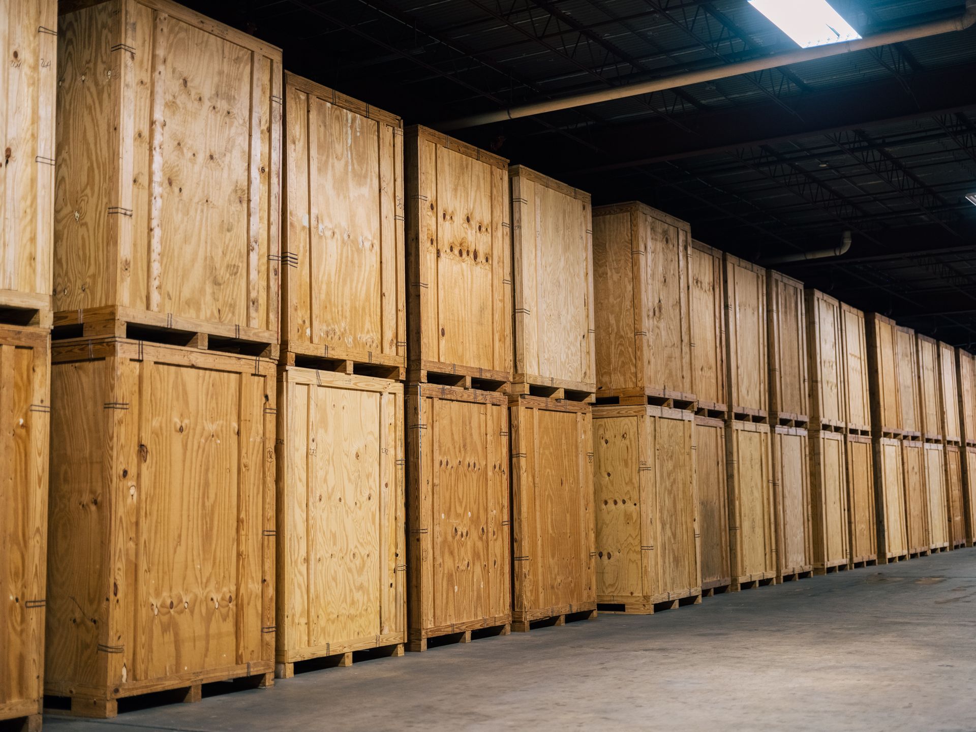Rows of wooden storage units in a dimly lit warehouse.