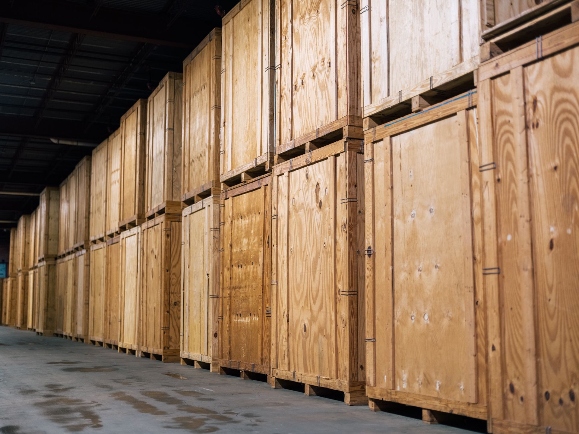 Rows of wooden storage units inside a warehouse, showing textures and details of the wood.